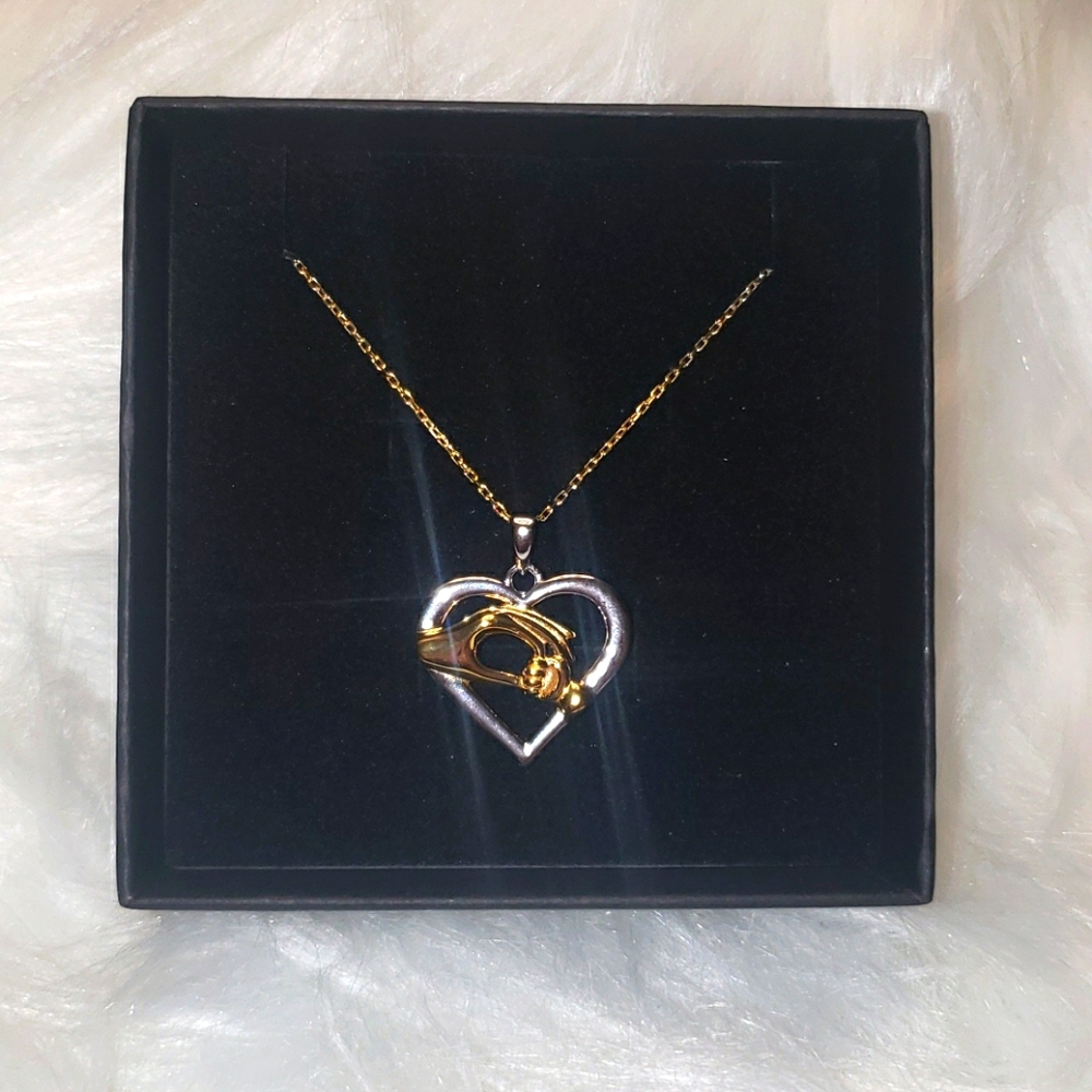 Child Holding Mom Hands Necklace